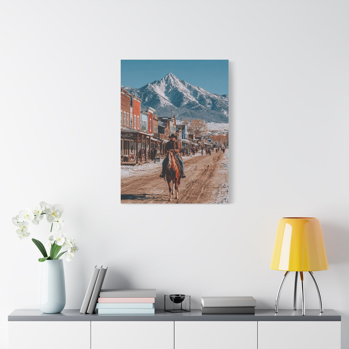Cowboy Riding Through a Frontier Mountain Town Wall Art & Canvas Print