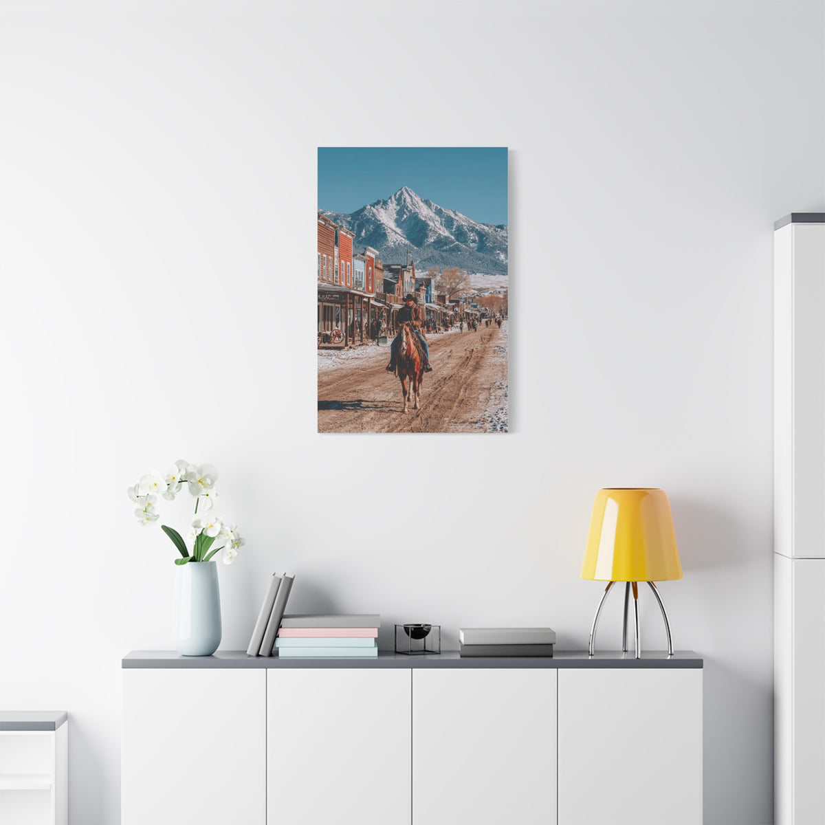 Cowboy Riding Through a Frontier Mountain Town Wall Art & Canvas Print